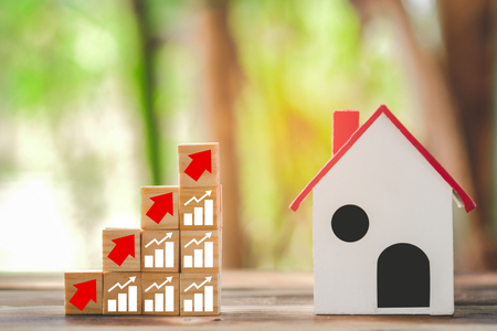 Wood block stacking as step stair and model house, business growth to success. Startup concepts with business strategy symbols on wooden cubes - business success concept.の写真素材