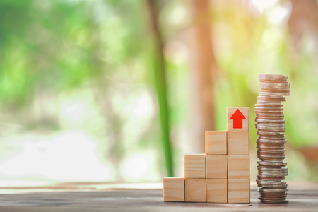 Wood block stacking as step stair and coins stacked, business growth to success.Startup concepts with business strategy symbols on wooden cubes - Risk management.の写真素材