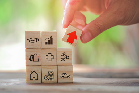 Wood block stacking as step stair and coins stacked, business growth to success.Startup concepts with business strategy symbols on wooden cubes - Risk management.の写真素材