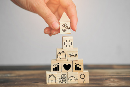 Wood block stacking as step stair and coins stacked, business growth to success.Startup concepts with business strategy symbols on wooden cubes - Risk management.の写真素材