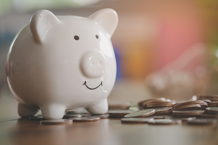 piggy bank on old wooden floor. ideas about saving money for future use - business success concept.の写真素材