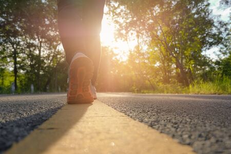 woman running on nature at autumn morning, Healthy lifestyle concept.の写真素材