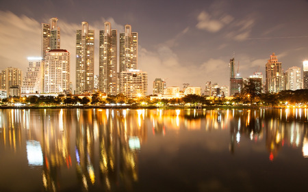 Bangkok at twilight with light and reflection, view from Benjakitti park Bangkok Thailand.の写真素材