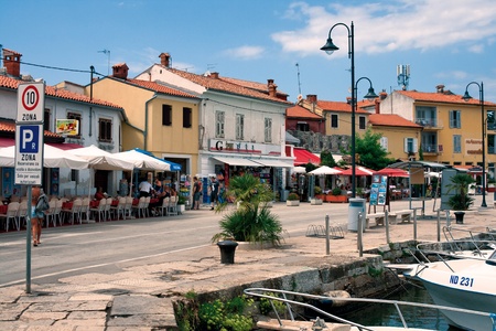 Novigrad, Croatia - August 08, 2011 - Seafront with restaurants and souvenir shops in old Istrian town. Town has retained its medieval structure and layout. のeditorial素材