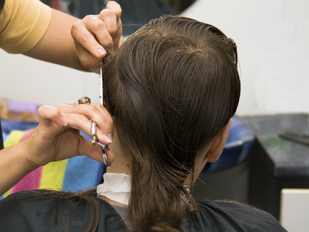 Boy having a hair cut at the hairdressersの写真素材