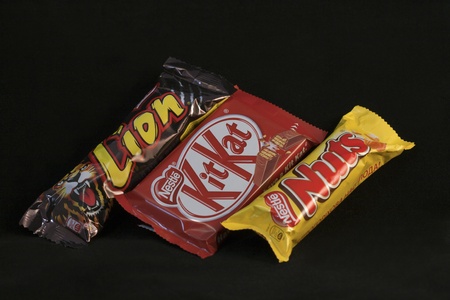Kiev, Ukraine - April 09, 2011: Lion, Kit Kat and Nuts chocolate bars from Nestle against black background in Kiev, Ukraine.のeditorial素材