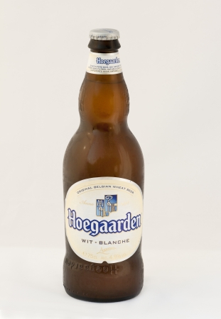 Hoegaarden wheat Belgian beer cold bottle against white background. The Belgian village of Hoegaarden had been known for its white beers since the Middle Ages. Hoegaarden wheat Belgian beer first brewed in 1445 is spiced with coriander and orange peel. Itのeditorial素材