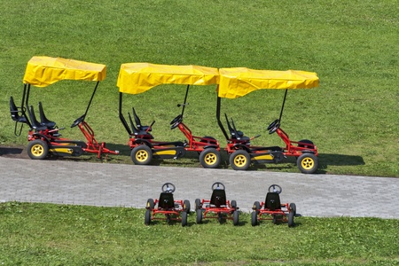 Four wheeled bicycles on pavement on the park の写真素材