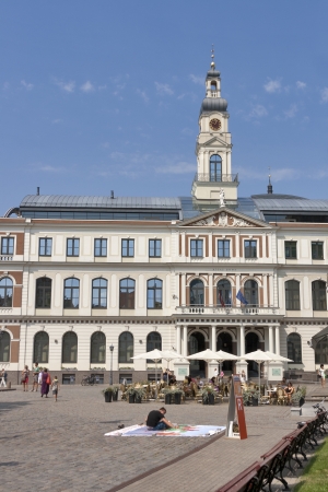 Riga, Latvia - July 29, 2012: People walk and have fun in front of Riga City ââCouncil building (Rigas Dome) in Old Town Riga, Latvia. Riga City Council is the government of Riga City, the capital of Latvia. It is located in the Riga Town Hall at the のeditorial素材