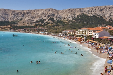 BASKA, CROATIA - AUGUST 08: People have a rest on the beach of mediterranean town of island Krk on August 08, 2012 in Baska, Croatia. Baska Voda is a municipality in the Split-Dalmatia County.のeditorial素材
