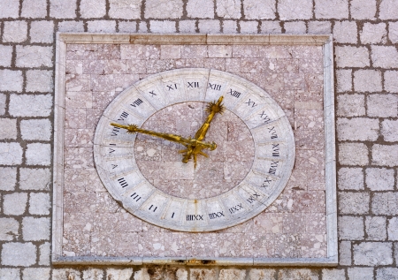 stony clock first mentioned in 1538 on townhall in city Krk with golden hands and roman clock dial  Croatiaの写真素材