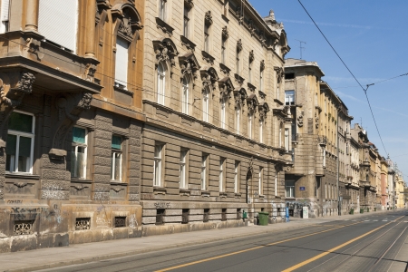 ZAGREB, CROATIA - AUGUST 21: Empty city street and old houses with wall graffiti and tram rails in Zagreb, Croatia on August 21, 2012.のeditorial素材