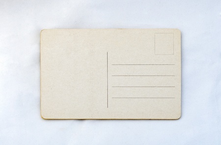 Old blank vintage post card on white grunge surfaceの写真素材