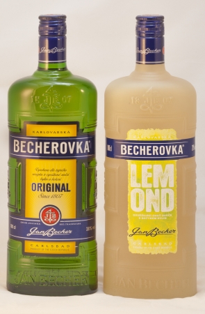 KIEV, UKRAINE - FEBRUARY 02, 2013: Two bottles of Karlovarska Becherovka Original and Lemond against white background. It is herbal bitters, often drunk as a digestive aid that is produced in Karlovy Vary, Czech Republic by the Jan Becher company now is oのeditorial素材