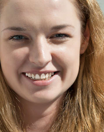 young attractive long blond hair woman looking at camera closeupの写真素材