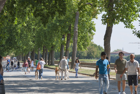 LUCCA, ITALY - SEPTEMBER 06, 2014: Unrecognizable pedestrians walk over the ancient fortified walls. Lucca is a city and comune in Tuscany, Central Italy, situated on the river Serchio.のeditorial素材