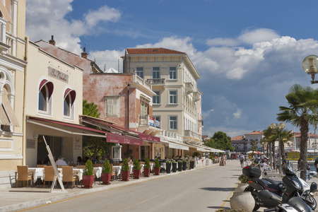 POREC, CROATIA - SEPTEMBER 14, 2014: Unrecognizable people rest in restaurants and walk along seafront. Porec almost 2,000 years old is a town and municipality on the western coast of the Istrian peninsula.のeditorial素材
