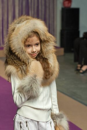 KIEV UKRAINE  AUGUST 28 2014: Association of Children's Fashion little girl model walks the runway at Kyiv Fashion 2014 show in KyivExpoPlaza exhibition center. It was the 27th edition of the popular Kyiv Fashion International Vogue Festival.のeditorial素材
