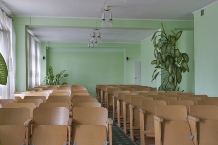Vintage empty classroom with wooden chairs and indoor plantsのeditorial素材