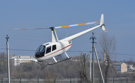 Helicopter R44 Robinson Raven 1 flying low over the groundのeditorial素材