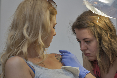 KIEV, UKRAINE - MAY 23, 2015: Tattoo artist works during International Tattoo Convention Kyiv Tattoo Collection 2015 organized by Planeta Tattoo studio in Art-factory Platforma.のeditorial素材