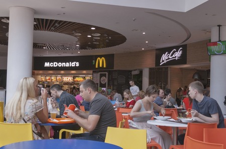 KIEV, UKRAINE - JULY 19, 2015: Unrecognizable people eating in a food court of Ocean Plaza biggest in Ukraine shopping mall with total area of 160.000 square meters, about 400 shops and 30 restaurantsのeditorial素材