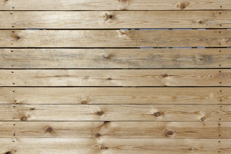 Planed wooden boards surface texture with branches close up background