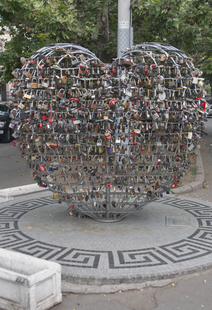 ODESSA, UKRAINE - JULY 16, 2014: Love padlocks hang on the metal structure in the shape of heart. The thousands of locks of loving couples symbolize eternal love forever.のeditorial素材