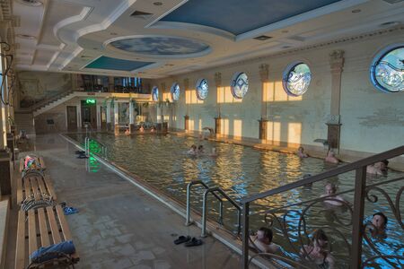 BEREHOVE, UKRAINE - SEPTEMBER 02,2015: Unrecognizable people swim in indoor thermal spa pool Zhayvoronok. Berehove city became famous for its unique thermal healing waters of high salinity.のeditorial素材