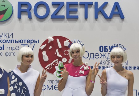 KIEV, UKRAINE - OCTOBER 11, 2015: Girls presenters work on Rozetka, Ukrainian online supermarket company booth during CEE 2015, largest electronics trade show of Ukraine in ExpoPlaza Exhibition Centerのeditorial素材