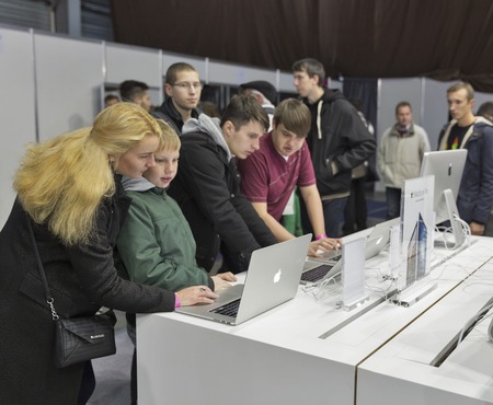 KIEV, UKRAINE - OCTOBER 11, 2015: People visit Apple, an American multinational technology company booth during CEE 2015, the largest electronics trade show of Ukraine in ExpoPlaza Exhibition Center.のeditorial素材