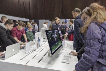 KIEV, UKRAINE - OCTOBER 11, 2015: People visit Apple, an American multinational technology company booth during CEE 2015, the largest electronics trade show of Ukraine in ExpoPlaza Exhibition Center.のeditorial素材
