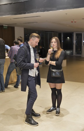 KIEV, UKRAINE - NOVEMBER 21, 2015: Unrecognized young visitors taste samples of Single Malt Scotch Whisky at 1st Ukrainian Whisky Dram Festival in Parkovy Exhibition Center.のeditorial素材