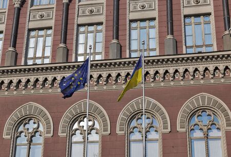 Flags of European Union and Ukraine in front of National Bank of Ukraine building in Kiev. Headquarters building was constructed between 1902 and 1934.のeditorial素材