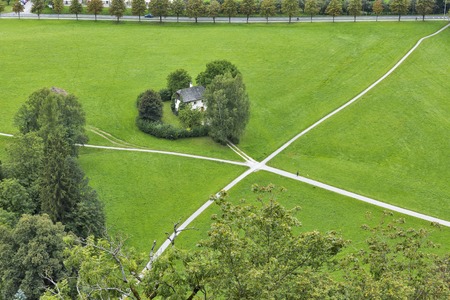 House standing on the crossroad in the field. Salzburg suburb, Austria.の写真素材