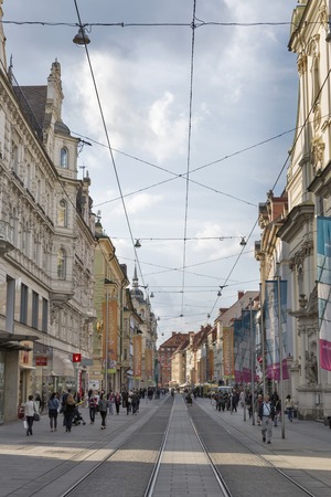 GRAZ, AUSTRIA - SEPTEMBER 11, 2015: Unrecognized people walk along tram rails on Herrengasse street in Graz Old Town. Graz is the capital of federal state of Styria and second largest city in Austria.のeditorial素材