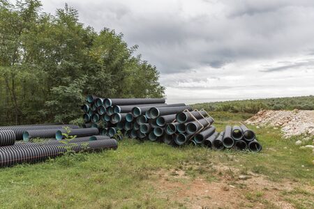 Pile of pvc construction pipes at a construction site in the forest