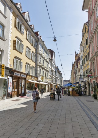 GRAZ, AUSTRIA - SEPTEMBER 11, 2015: Unrecognized people walk along Schmiedgasse street in Graz Old Town. Graz is the capital of federal state of Styria and second largest city in Austria.のeditorial素材