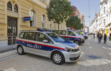 GRAZ, AUSTRIA - SEPTEMBER 11, 2015: Unrecognized people walk along Schmiedgasse street and local police station in Graz Old Town. Graz is the capital of Styria and second largest city in Austria.のeditorial素材