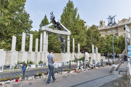 BUDAPEST, HUNGARY - SEPTEMBER 24, 2015: Unrecognized people walk along a memorial dedicated to the victims of Nazi Occupation during the Second World War.のeditorial素材