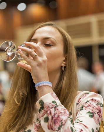KIEV, UKRAINE - JUNE 04, 2016: Unrecognized visitor taste white wine at Kyiv Wine Festival organized by Good Wine company in Parkovy Exhibition Center.のeditorial素材