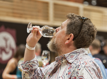 KIEV, UKRAINE - JUNE 04, 2016: Unrecognized man visitor taste wine at Kyiv Wine Festival organized by Good Wine company in Parkovy Exhibition Center.のeditorial素材