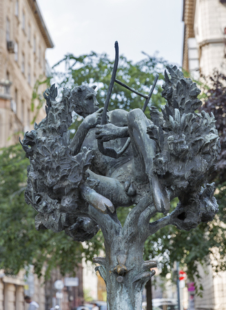 BUDAPEST, HUNGARY - SEPTEMBER 23, 2015: Forest faun bronze street fountain statue closeup. Statue by Laszlo Marton, 1985, on Erzsebet Boulevard.のeditorial素材