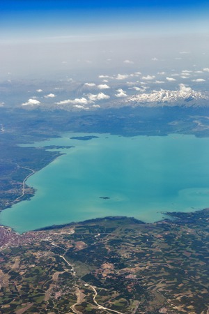 Aerial view from airplane of Lake Beysehir and snow covered mountains in Turkey. It is the largest freshwater lake in Turkeyの写真素材