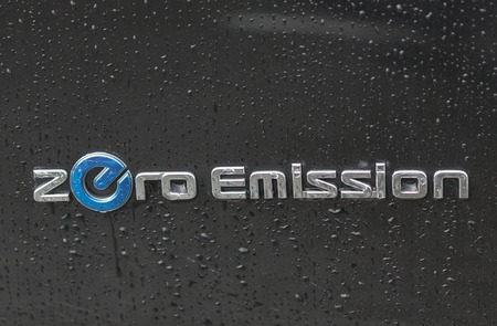 KIEV, UKRAINE - JUNE 10, 2016: Nissan Zero Emission electric hybrid car logo closeup outdoor under the rain.のeditorial素材