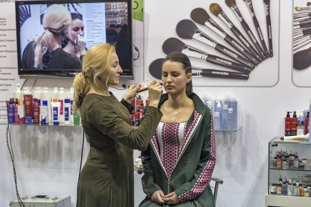 KIEV, UKRAINE - MARCH 25, 2016: Unrecognized woman cosmetologist demonstrates makeup blending skills at 16th National Congress of Beauty Industry Estet Beauty Expo 2016 in IEC.のeditorial素材
