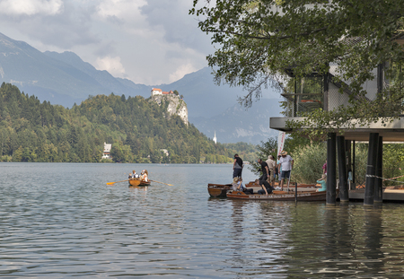 BLED, SLOVENIA - SEPTEMBER 10, 2016: Unrecognized people floating on boats on Lake Bled. Bled Lake is one of the picturesque sites of the nation.のeditorial素材