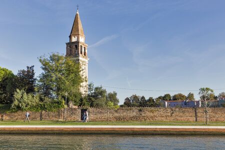 MAZZORBO, ITALY - SEPTEMBER 22, 2016: Unrecognized people walk along canal embankment and Campiello San Michele Arcangelo.のeditorial素材