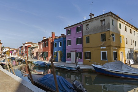 BURANO, ITALY - SEPTEMBER 22, 2016: Unrecognized people on bridge over canal. Burano is an island in Venetian Lagoon known for its lace works and brightly colored homes which attract thousands touristのeditorial素材