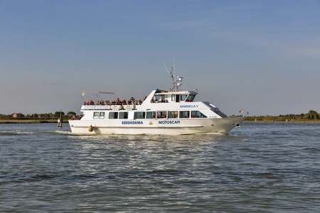 BURANO, ITALY - SEPTEMBER 22, 2016: People travel by touristic ship Marinella V between the islands in Venice lagoon. Burano is an island known for its lace works and brightly colored homes.のeditorial素材